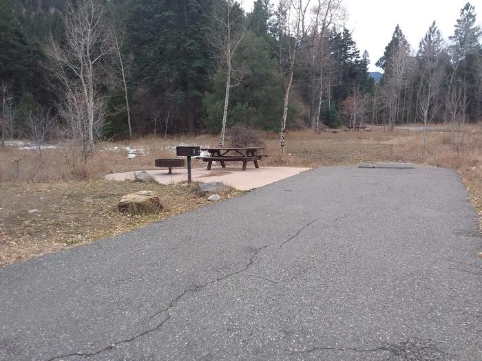 Site 2 with a fire ring, picnic table, camp grill, and parking.