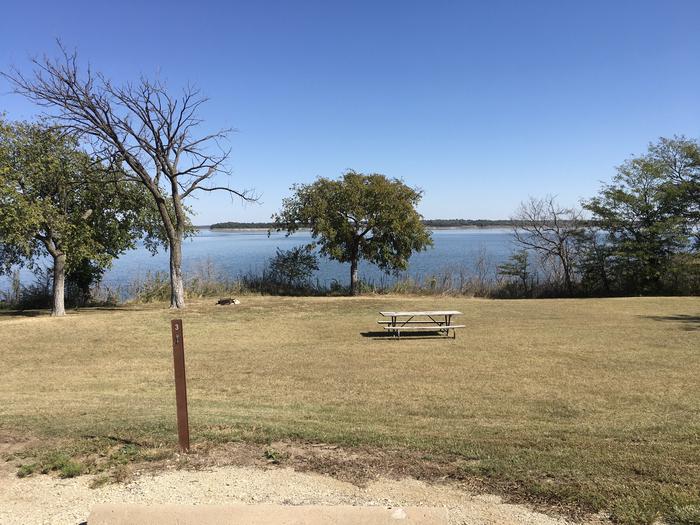 A photo of Site D003 of Loop D at CURTIS CREEK with Picnic Table, Fire Pit, Shade, Waterfront