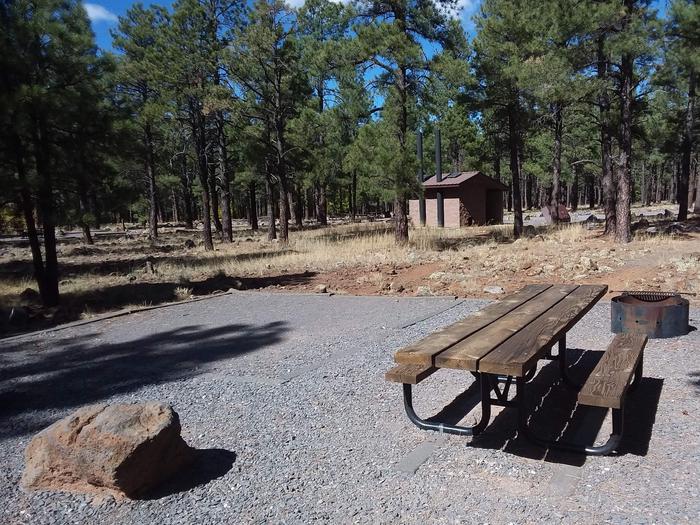 Site 13 with a picnic table, campfire ring, and near bathroom distance.Campsite 13 