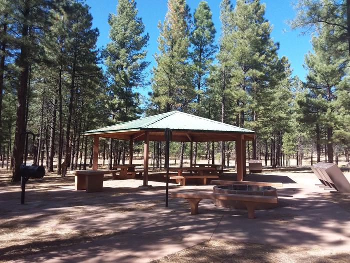 Group Campsite B with multiple benches and picnic tables, a grill, pavilion and restrooms