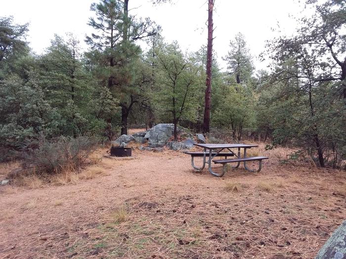 Site 34 with table and campfire ring next to large rocksCampsite 34 