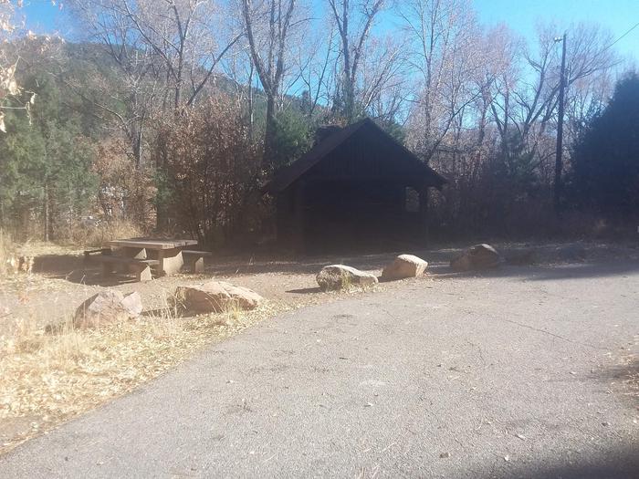 Site 7 with a picnic table, fire ring, parking, and a shelter unit.