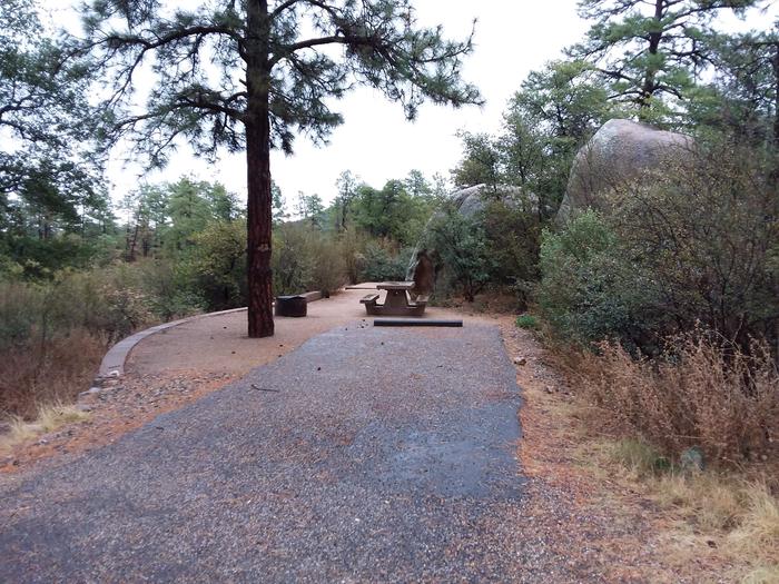 Yavapai Campsite 01 with a picnic table, fire ring and paved parking space beside giant bouldersYavapai Campsite 01 with a picnic table, fire ring and paved parking space beside two giant boulders