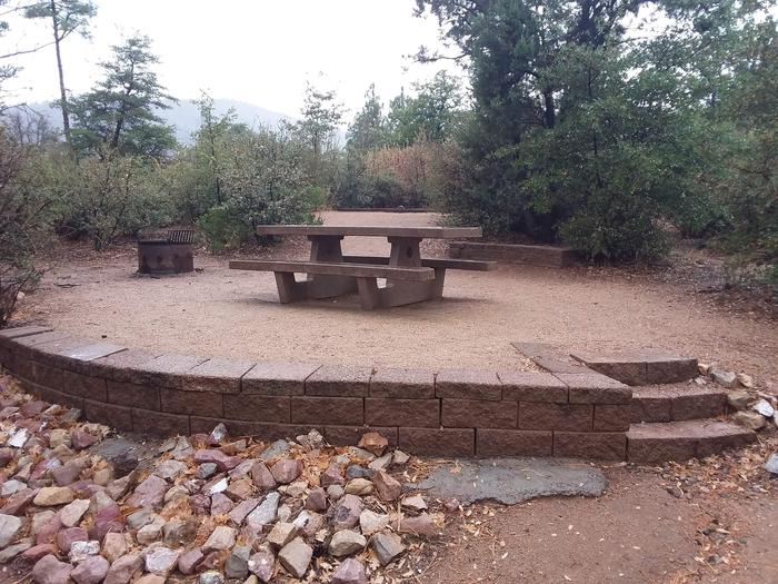 Yavapai Campsite 11 stone wall platform with a picnic table and fire ring