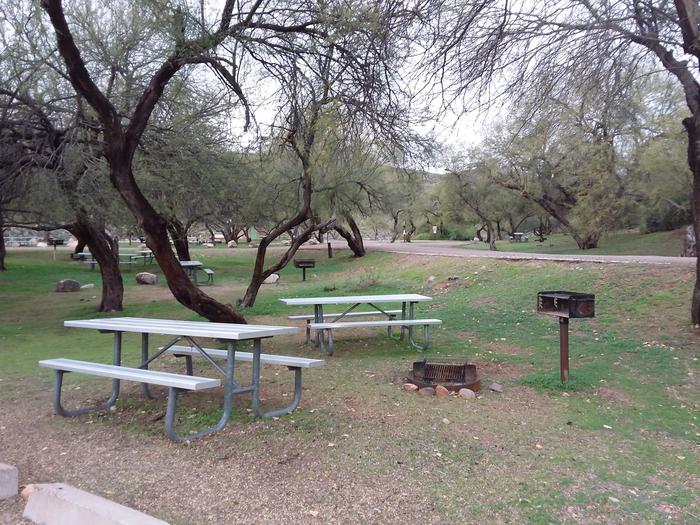 Site 31B with picnic tables, a fire ring, camp grill, and parking.