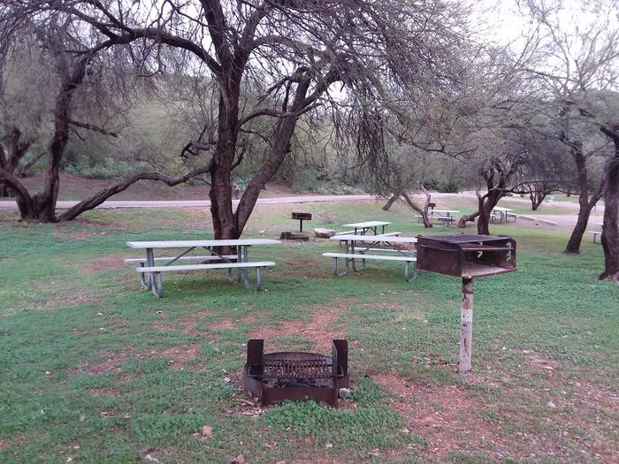 Campsite 43 at Burnt Corral Campground with picnic tables, a fire ring, camp grill, and parking.