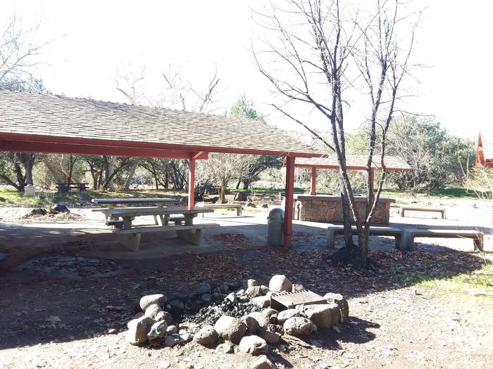 Picnic area with picnic table with shade and a fire ring.