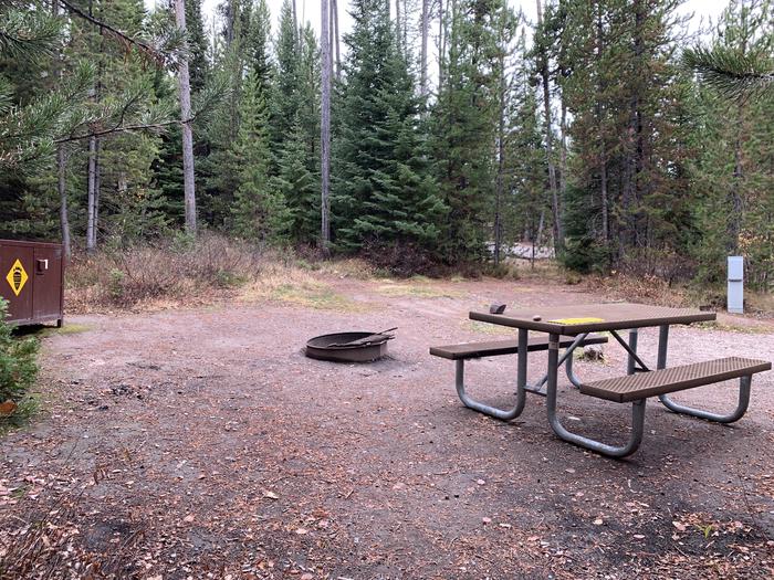 A photo of Site 35 of Loop 1 at Signal Mountain Lodge Campground with Picnic Table, Electricity Hookup, Fire Pit, Shade, Food Storage
