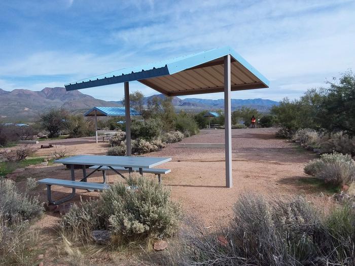 Site 166 with a picnic table, fire ring, shade structure, and parkingSite 166 with a picnic table, fire ring, shade structure, and parking.