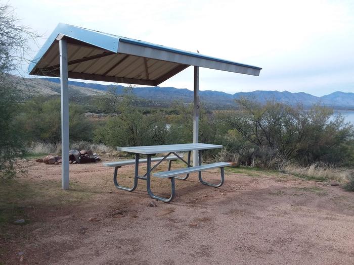T9 Campsite at Cholla Campground with a picnic table, fire ring, shade structure, and parking.
