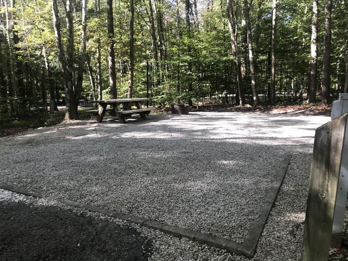 A photo of Site A018 of Loop A at TWIN KNOBS CAMPGROUND with Picnic Table, Electricity Hookup, Fire Pit, Shade, Tent Pad, Lantern Pole