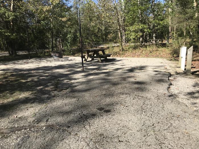 A photo of Site B018 of Loop B at TWIN KNOBS CAMPGROUND with Picnic Table, Electricity Hookup, Fire Pit, Shade, Tent Pad, Lantern Pole