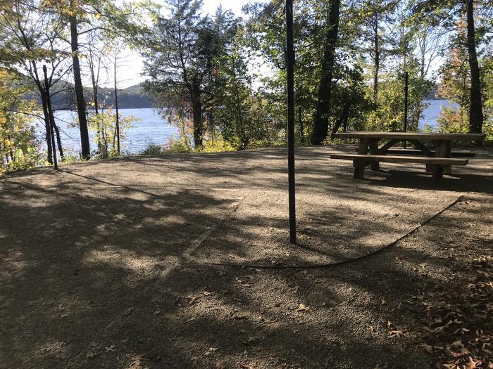 A photo of Site F022 of Loop F at TWIN KNOBS CAMPGROUND with Picnic Table, Fire Pit, Shade, Tent Pad, Waterfront, Lantern Pole