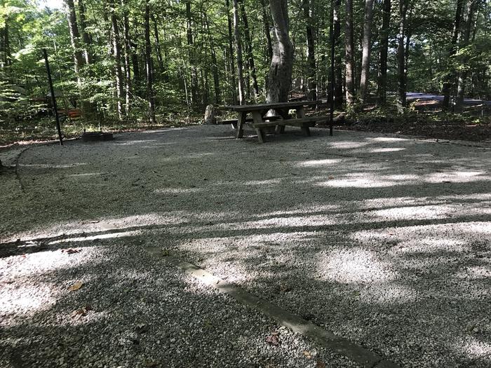 A photo of Site F029 of Loop F at TWIN KNOBS CAMPGROUND with Picnic Table, Fire Pit, Shade, Tent Pad, Lantern Pole