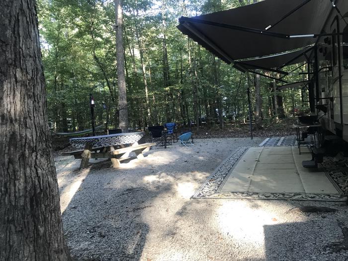 A photo of Site J013 of Loop J at TWIN KNOBS CAMPGROUND with Picnic Table, Electricity Hookup, Fire Pit, Shade, Tent Pad, Lantern Pole