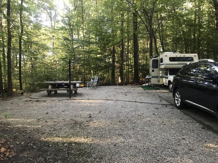 A photo of Site J017 of Loop J at TWIN KNOBS CAMPGROUND with Picnic Table, Electricity Hookup, Fire Pit, Shade, Tent Pad, Lantern Pole
