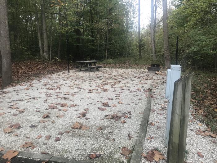 A photo of Site A006 of Loop A at TWIN KNOBS CAMPGROUND with Picnic Table, Electricity Hookup, Fire Pit, Shade, Tent Pad, Lantern Pole