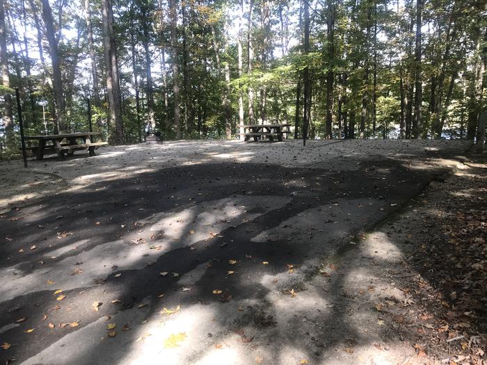 A photo of Site J009 of Loop J at TWIN KNOBS CAMPGROUND with Picnic Table, Electricity Hookup, Fire Pit, Shade, Tent Pad, Waterfront, Lantern Pole