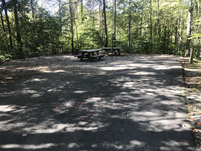 A photo of Site A027 of Loop A at TWIN KNOBS CAMPGROUND with Picnic Table, Electricity Hookup, Fire Pit, Shade, Tent Pad, Lantern Pole