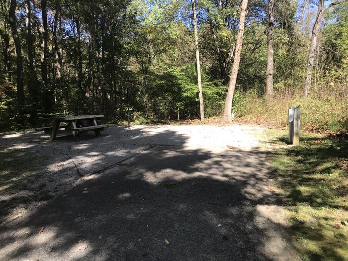 A photo of Site A025 of Loop A at TWIN KNOBS CAMPGROUND with Picnic Table, Electricity Hookup, Fire Pit, Shade, Tent Pad, Lantern Pole