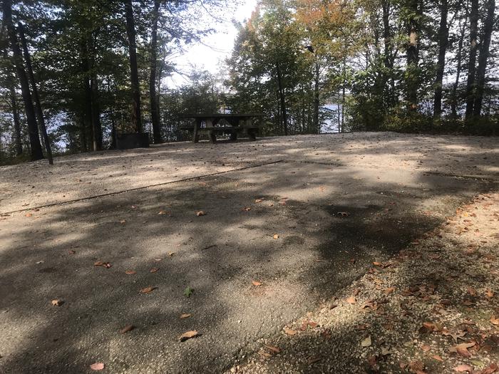 A photo of Site F020 of Loop F at TWIN KNOBS CAMPGROUND with Picnic Table, Fire Pit, Shade, Tent Pad, Waterfront, Lantern Pole