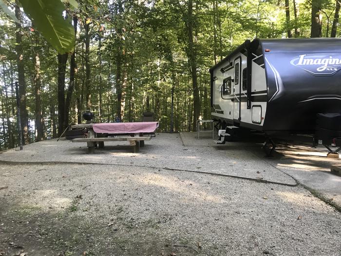 A photo of Site J008 of Loop J at TWIN KNOBS CAMPGROUND with Picnic Table, Electricity Hookup, Fire Pit, Shade, Tent Pad, Waterfront, Lantern Pole