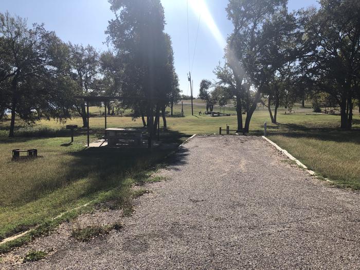 Back in site suitable for medium to small RVs; covered picnic shelter, fire ring, and grill on site; water and 30amp electric hook ups available; partially shaded Site open April 1st through September 30th