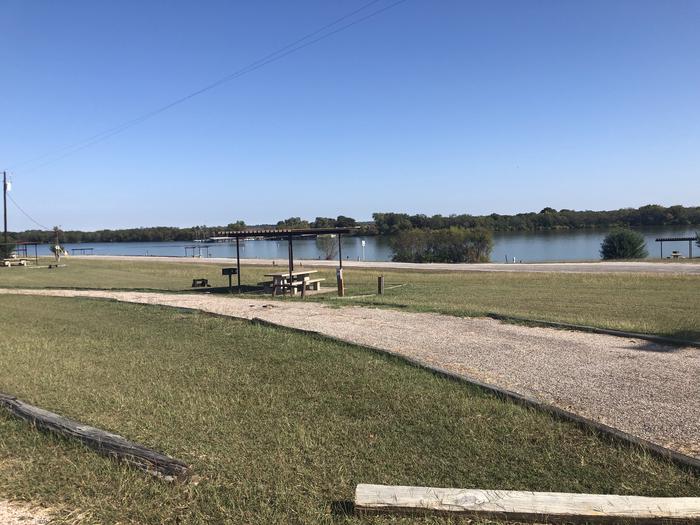 Pull through site suitable for larger RVs; sheltered picnic area, fire ring, and grill onsite; water and 30 amp electric hookups availableSite open April 1st through September 30th