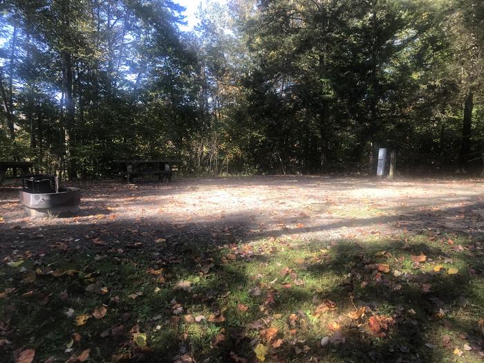 A photo of Site A030 of Loop A at TWIN KNOBS CAMPGROUND with Picnic Table, Electricity Hookup, Fire Pit, Shade, Tent Pad, Waterfront, Lantern Pole