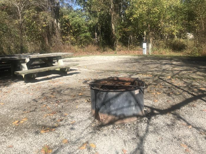 A photo of Site A034 of Loop A at TWIN KNOBS CAMPGROUND with Picnic Table, Electricity Hookup, Fire Pit, Shade, Tent Pad, Lantern Pole