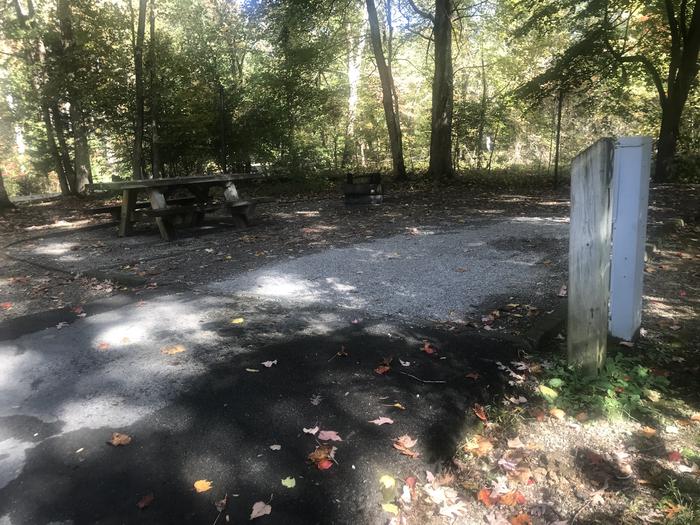 A photo of Site A028 of Loop A at TWIN KNOBS CAMPGROUND with Picnic Table, Electricity Hookup, Fire Pit, Shade, Tent Pad, Lantern Pole