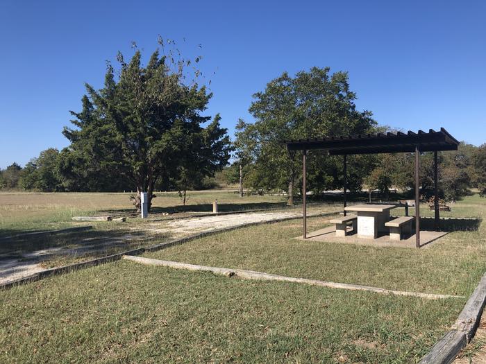 Pull through site suitable for large to medium RVs; sheltered picnic area, fire ring, and grill on site; water and 30 amp electrical hookups; partially shadedSite closed for administrative reasons 