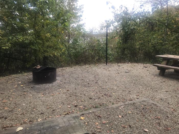 A photo of Site F019 of Loop F at TWIN KNOBS CAMPGROUND with Picnic Table, Fire Pit, Shade, Tent Pad, Waterfront, Lantern Pole