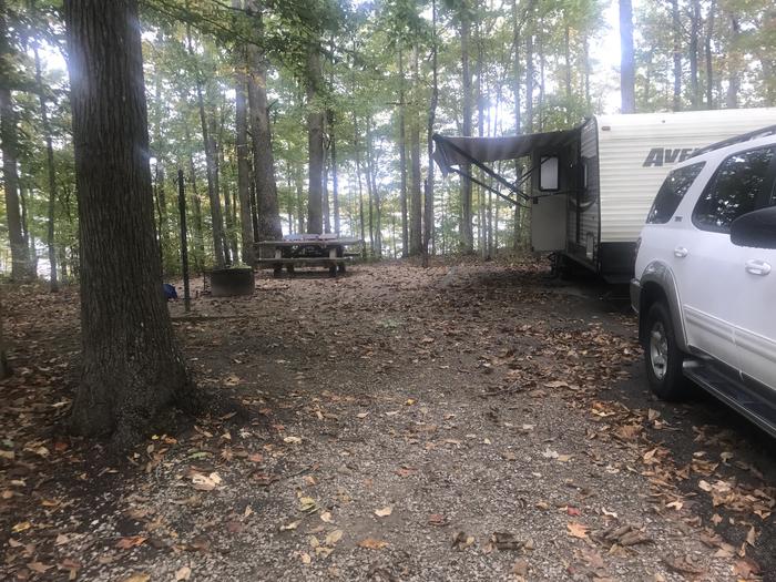 A photo of Site J011 of Loop J at TWIN KNOBS CAMPGROUND with Picnic Table, Electricity Hookup, Fire Pit, Shade, Tent Pad, Waterfront, Lantern Pole