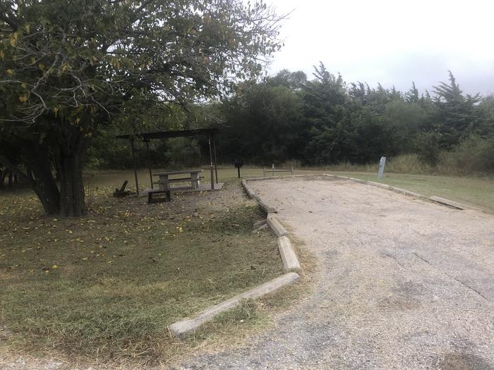 Back in site suitable for large to medium RVs; covered picnic area, fire ring, and grill on site; water and 50 amp electric hookups available; partially shadedSite open year round