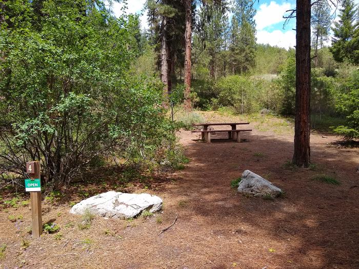A camping area with picnic table, next to campsite driveway.Black Rock Site 4 camping spot, near the driveway.