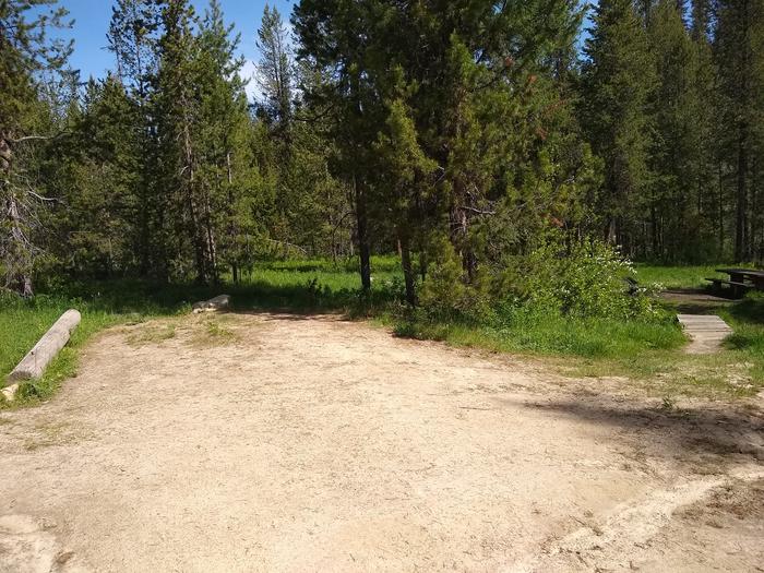 A longitudinal view of the parking area at Site 9, Edna Creek Campground.An alternate angle of the parking area for Site 9 at Edna Creek. Campers use a foot bridge to reach the campsite.