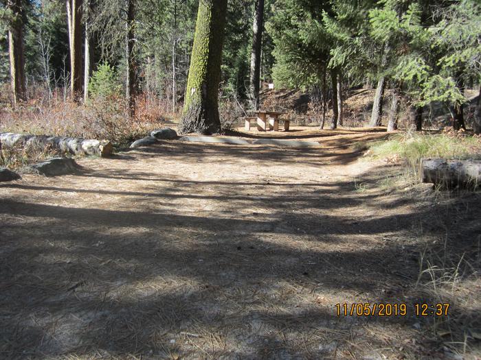 A paved driveway leading to a small campsite.Ten Mile Site 8.