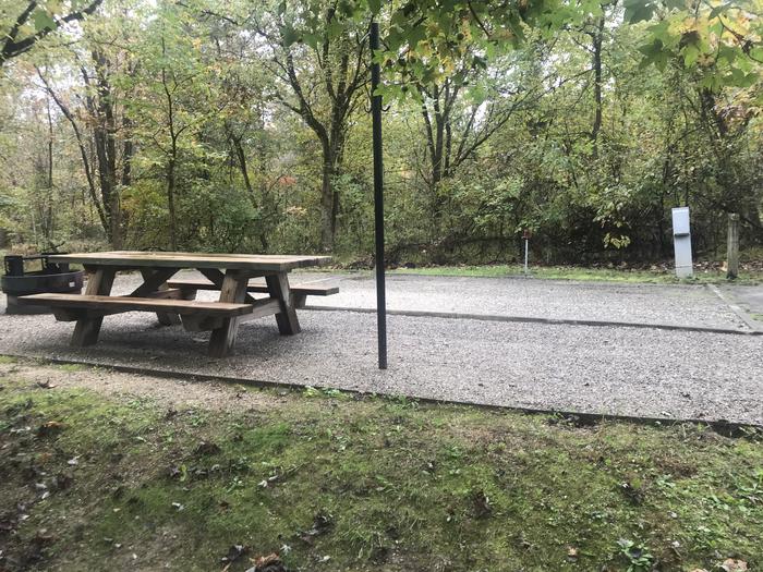 A photo of Site A039 of Loop A at TWIN KNOBS CAMPGROUND with Picnic Table, Electricity Hookup, Fire Pit, Shade, Tent Pad, Lantern Pole, Water Hookup
