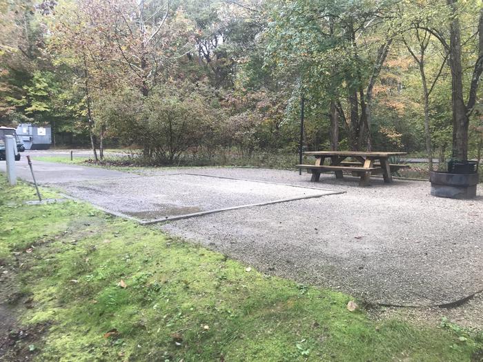 A photo of Site A039 of Loop A at TWIN KNOBS CAMPGROUND with Picnic Table, Electricity Hookup, Fire Pit, Shade, Tent Pad, Lantern Pole, Water Hookup