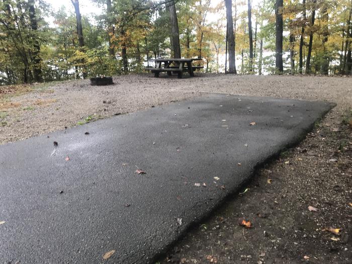 A photo of Site D011 of Loop D at TWIN KNOBS CAMPGROUND with Picnic Table, Fire Pit, Shade, Tent Pad, Waterfront, Lantern Pole