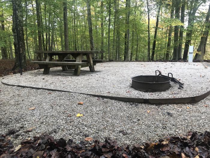 A photo of Site H002 of Loop H at TWIN KNOBS CAMPGROUND with Picnic Table, Electricity Hookup, Fire Pit, Shade, Tent Pad, Lantern Pole