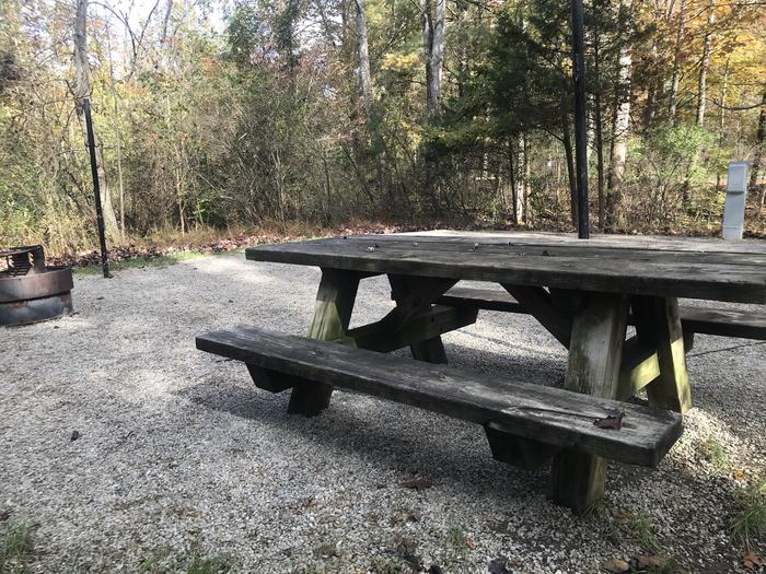 A photo of Site H018 of Loop H at TWIN KNOBS CAMPGROUND with Picnic Table, Electricity Hookup, Fire Pit, Shade, Tent Pad, Lantern Pole