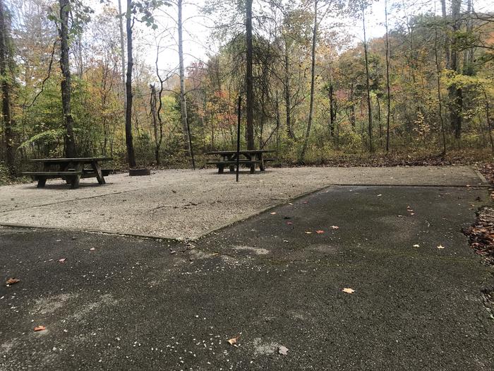 A photo of Site H013 of Loop H at TWIN KNOBS CAMPGROUND with Picnic Table, Electricity Hookup, Fire Pit, Shade, Tent Pad, Lantern Pole