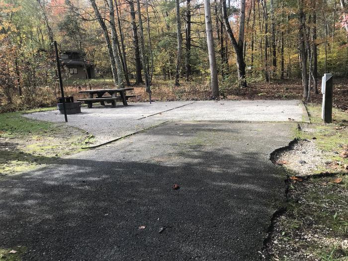 A photo of Site H011 of Loop H at TWIN KNOBS CAMPGROUND with Picnic Table, Electricity Hookup, Fire Pit, Shade, Tent Pad, Lantern Pole