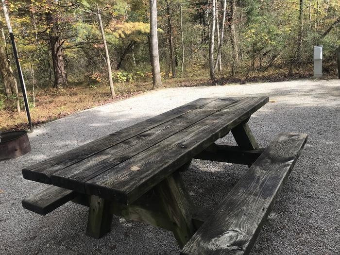 A photo of Site H016 of Loop H at TWIN KNOBS CAMPGROUND with Picnic Table, Electricity Hookup, Fire Pit, Shade, Tent Pad, Lantern Pole