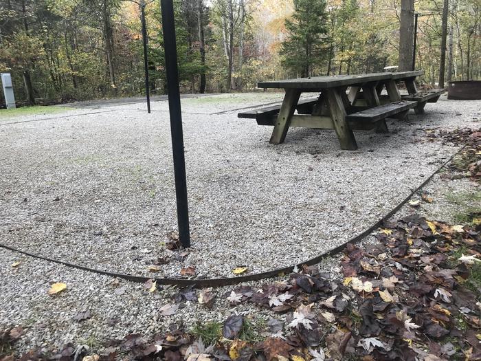 A photo of Site H012 of Loop H at TWIN KNOBS CAMPGROUND with Picnic Table, Electricity Hookup, Fire Pit, Shade, Tent Pad, Lantern Pole