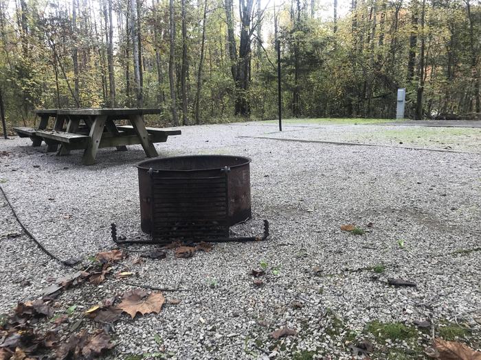 A photo of Site H012 of Loop H at TWIN KNOBS CAMPGROUND with Picnic Table, Electricity Hookup, Fire Pit, Shade, Tent Pad, Lantern Pole