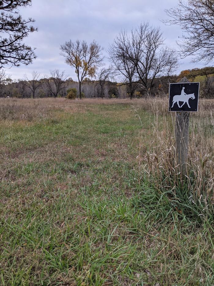 Small sign showing the horse trail route