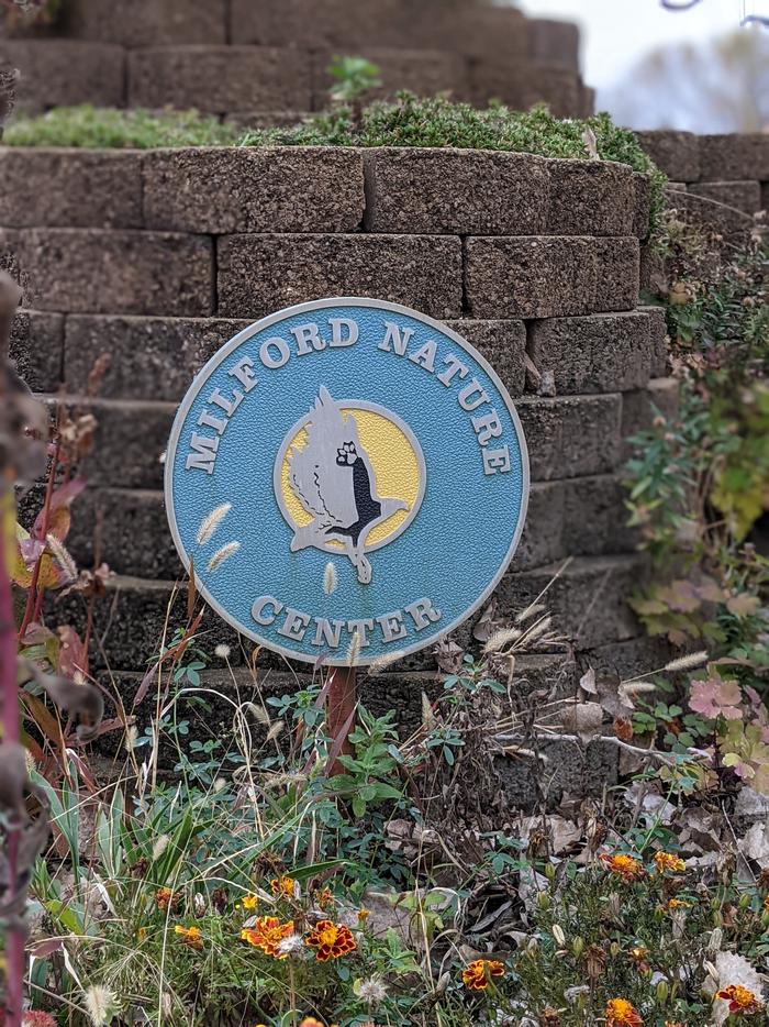 Milford Nature Center emblem at Outlet Park